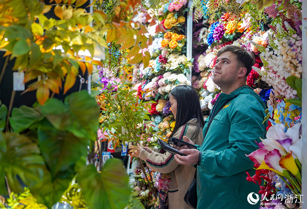 在浙江義烏國際商貿城，外商（右）正在選購小商品。人民網 章勇濤攝  
