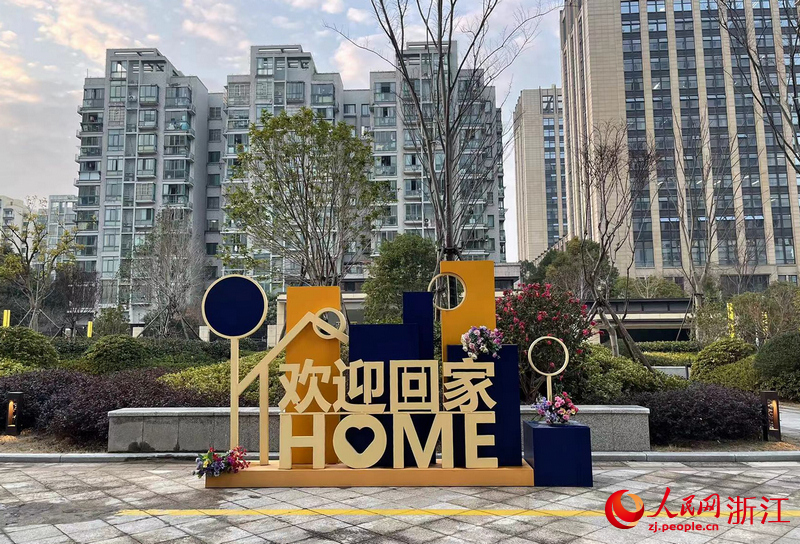 安置小區云峰社區門口打出“歡迎回家”字樣。李彩恩攝