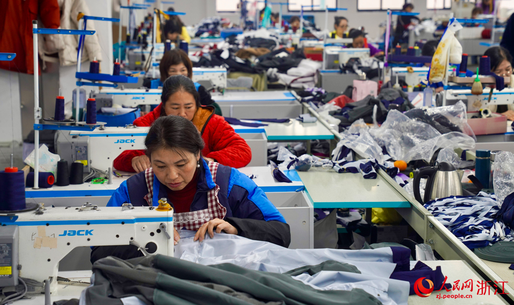 三門一家沖鋒衣企業的生產車間里，工人們正火力全開，趕制訂單。人民網記者 郭揚攝