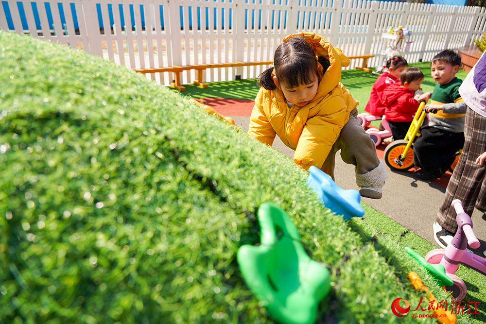 在浙江省嘉興市秀洲區新塍鎮一托育園，孩子們在戶外快樂地玩耍。人民網 章勇濤攝