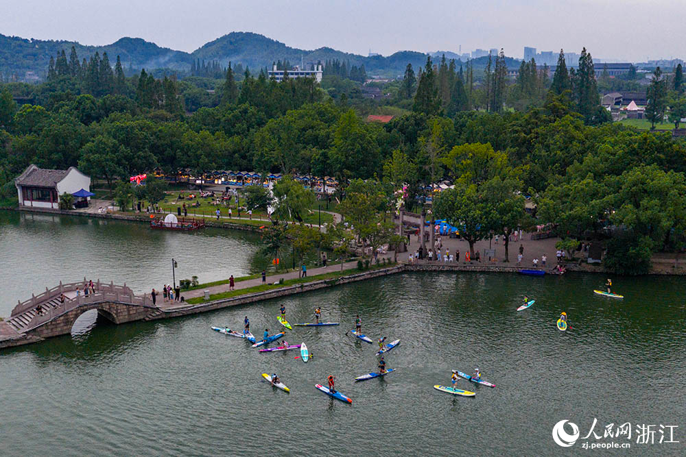8月10日，在寧波市江北區慈湖，青年夜校學員和運動員一起劃槳板。人民網 章勇濤攝