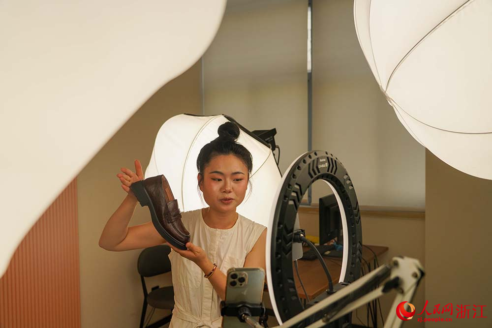 浙江省溫州市鹿城區的鞋企生產車間，主播在直播間里直播帶貨。人民網 章勇濤攝