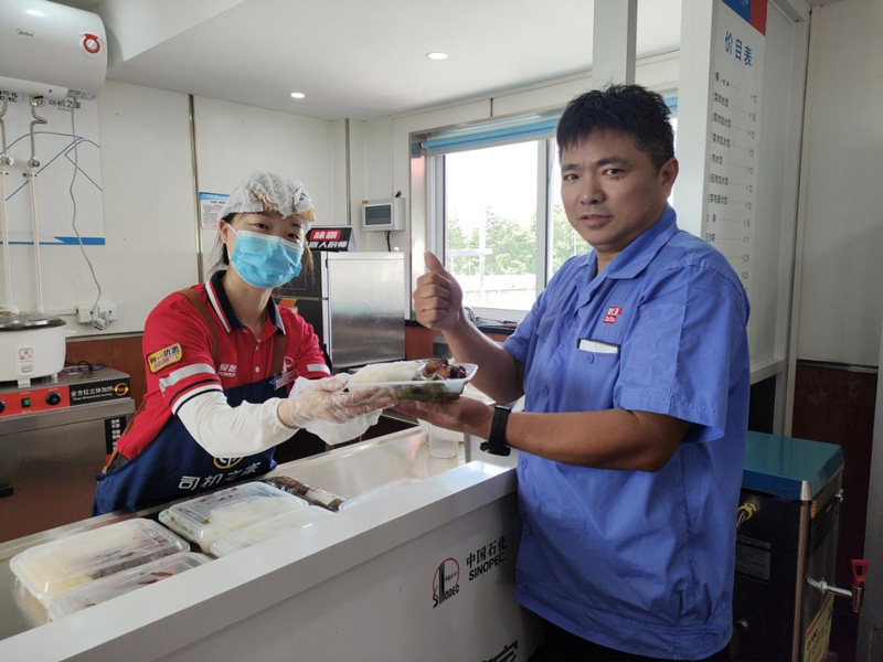 貨車司機朱師傅在就餐窗口處對菜品點贊。中國石化浙江石油分公司供圖